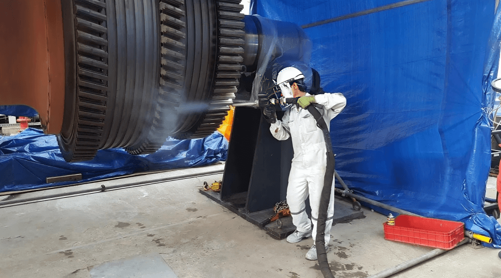 Industrial cleaning specialists sanitising a production floor